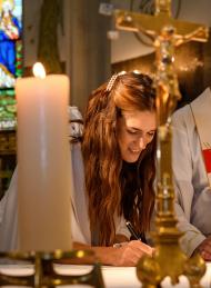 beautiful bride signing marriage certificate