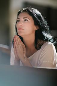 beautiful woman with a rosary praying