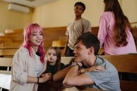 group of young students socializing in a classroom