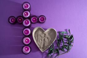 Lent Symbolism. Candles and ashes on purple background