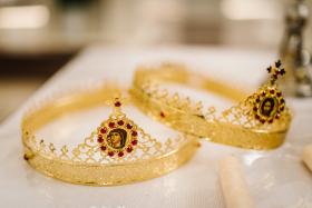 Two golden crown with red gemstones on altar in church. traditio