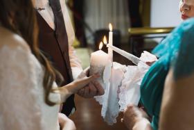 Wedding ceremony, paraphernalia, the bride and groom hold a large candle in their hand.